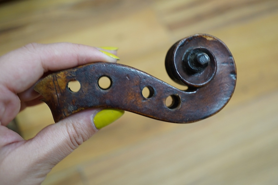 A quantity of violin parts and violins, a ukelele, a double bass scroll, a pinfold metronome, a violin case by Hill, a viola etc. Condition - for restoration